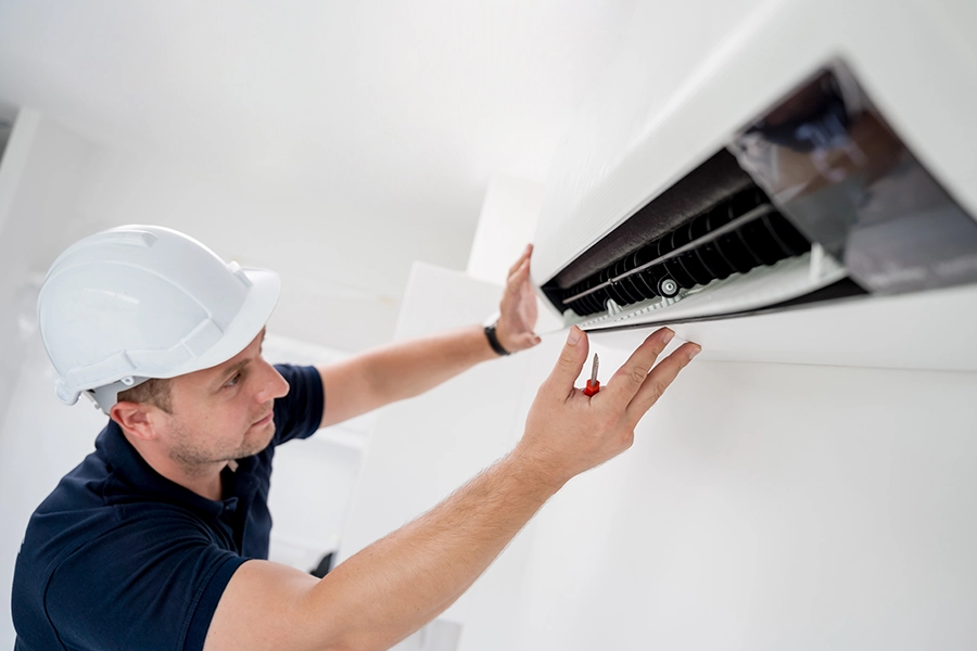 An HVAC technician working on an AC replacement for a home in Lincoln, IL.