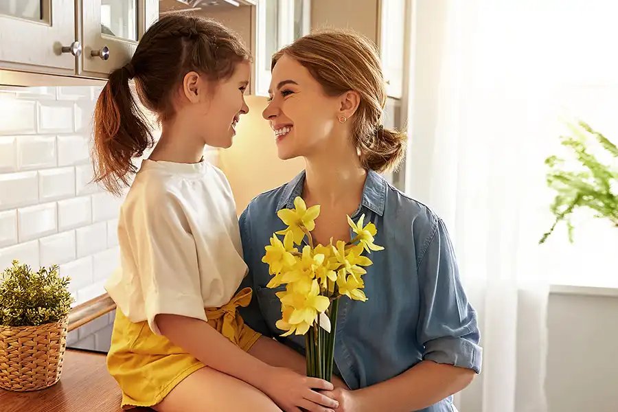 Tarter Brother’s Mechanical Inc. – a mother & young daughter with a small bouquet of daffodils, smiling at each other in the comfort of their new air conditioning system.